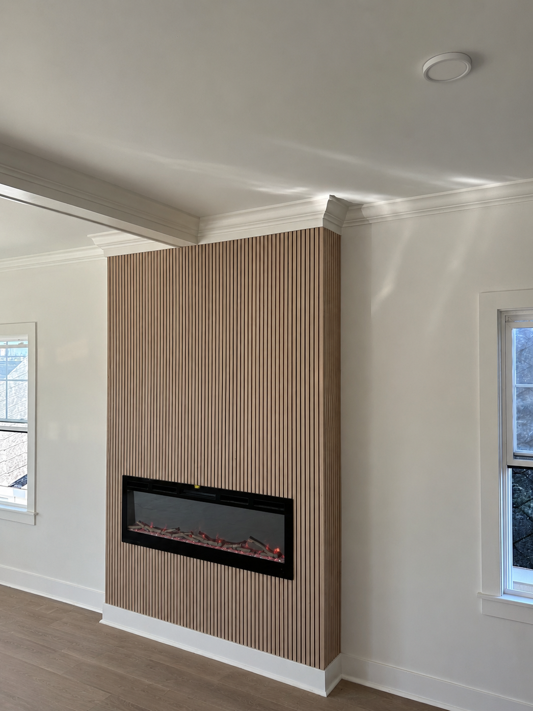 Completed fireplace wall with vertical wood slats